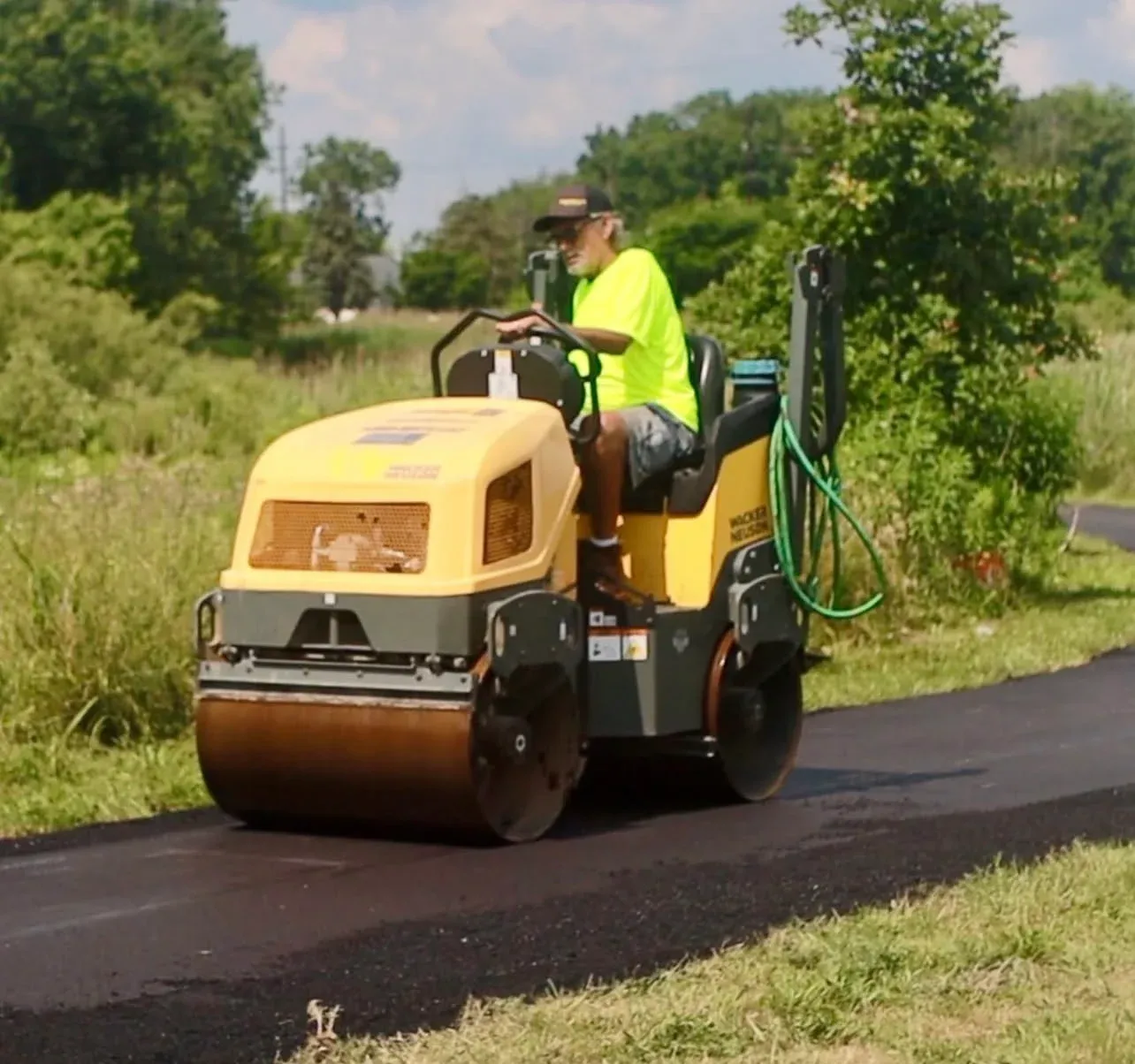 Editorial image of an asphalt roller at a federal construction worksite.